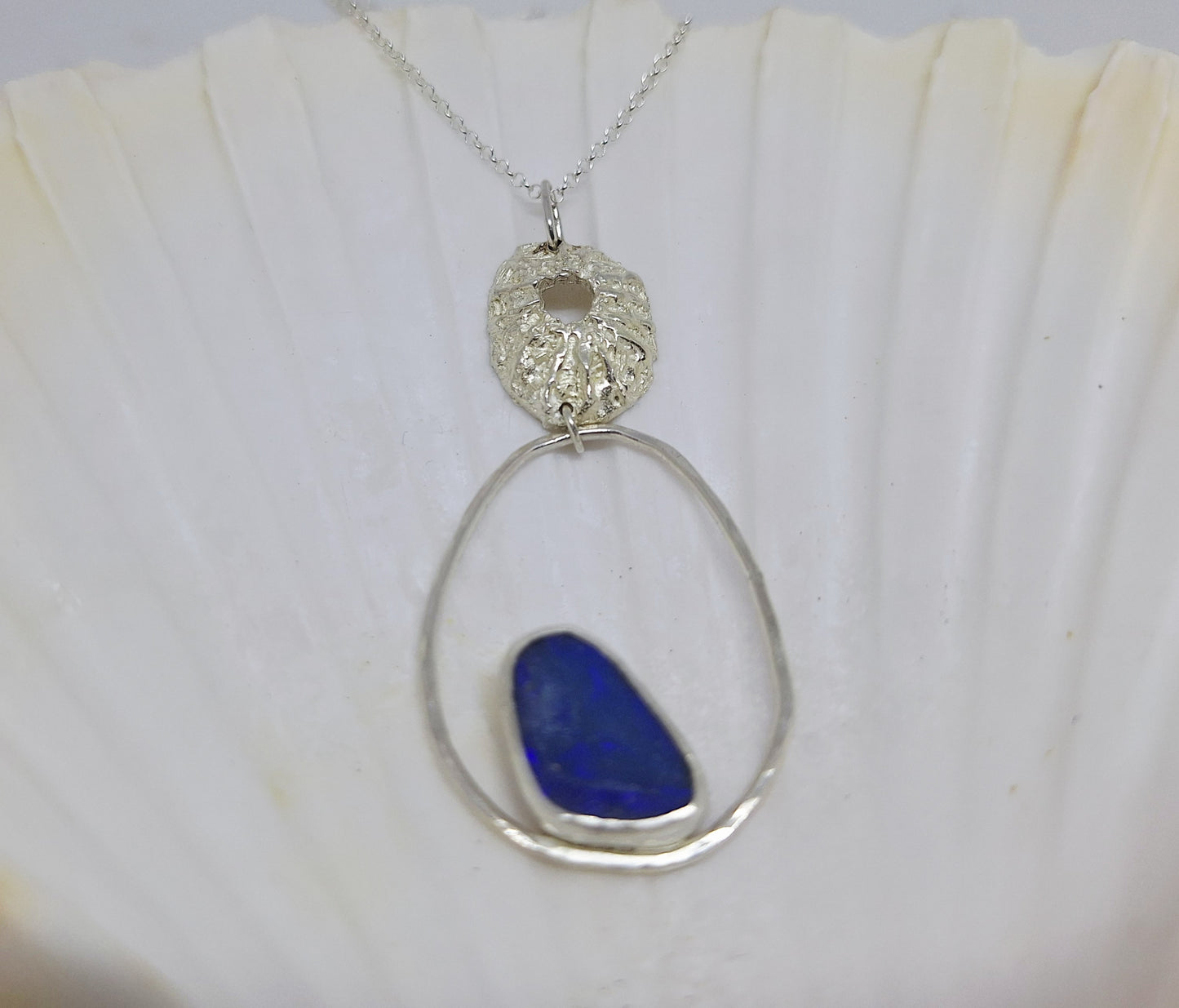Limpet, pebble and opal pendant