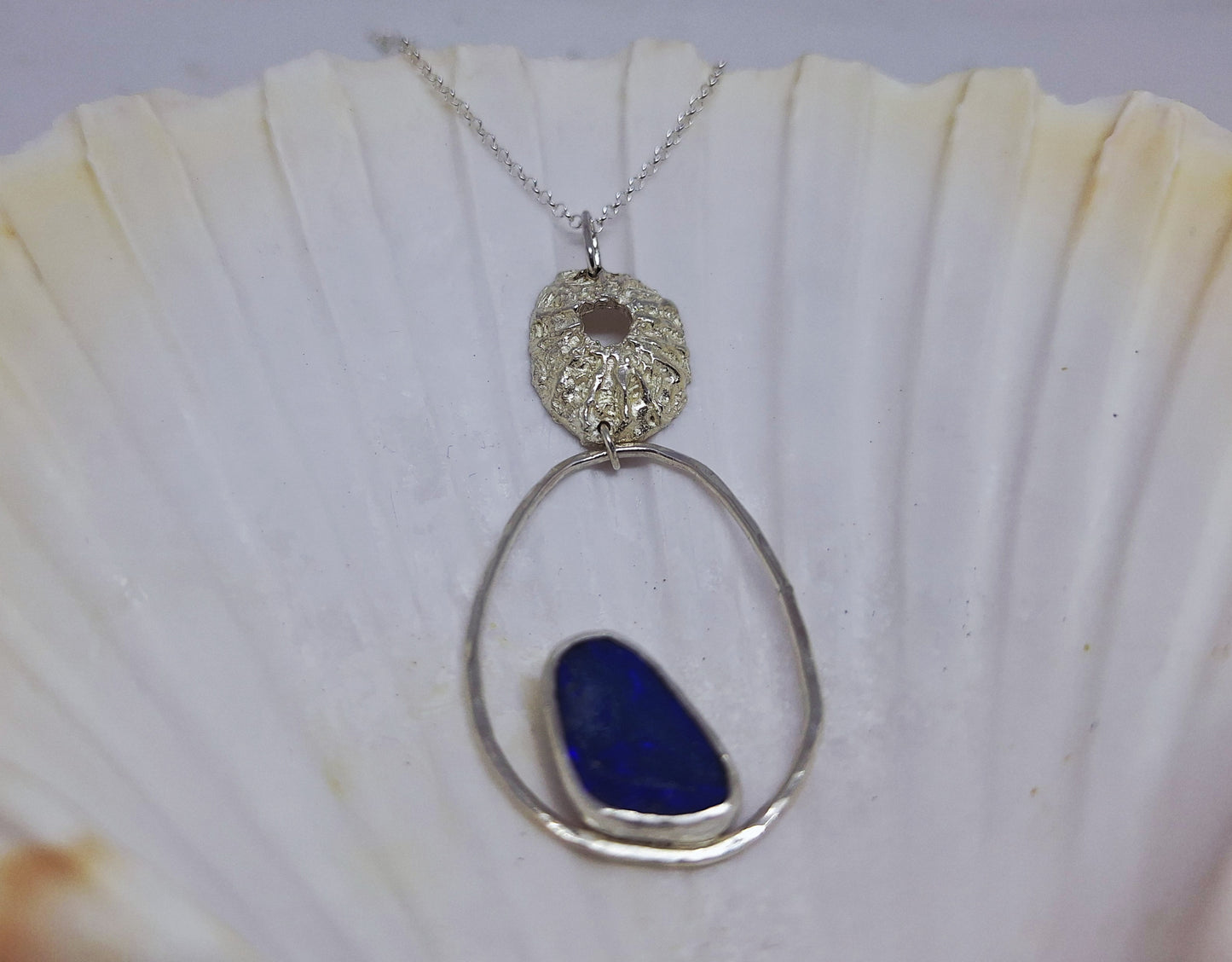 Limpet, pebble and opal pendant